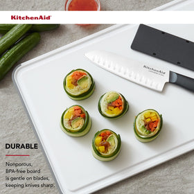 KitchenAid plastic cutting board is dishwasher safe for quick cleanup.