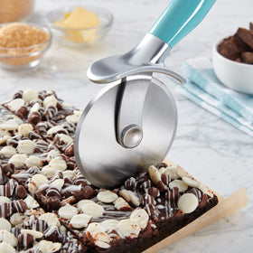 KitchenAid pizza wheel blade close-up showing a sharp 430 stainless steel blade for clean cuts.