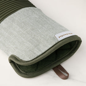 KitchenAid Evergreen oven mitts in use lifting a hot pot