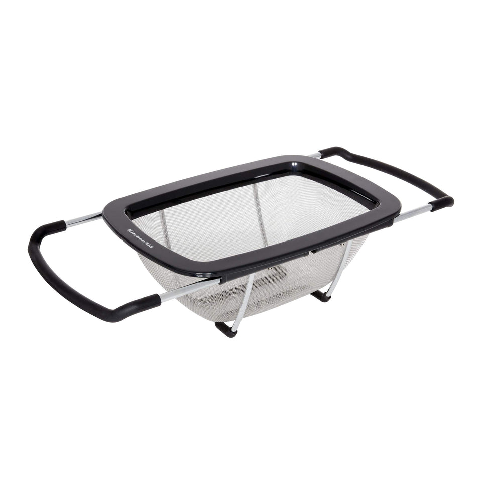 KitchenAid expandable colander with adjustable handles spanning a wide sink for drainage