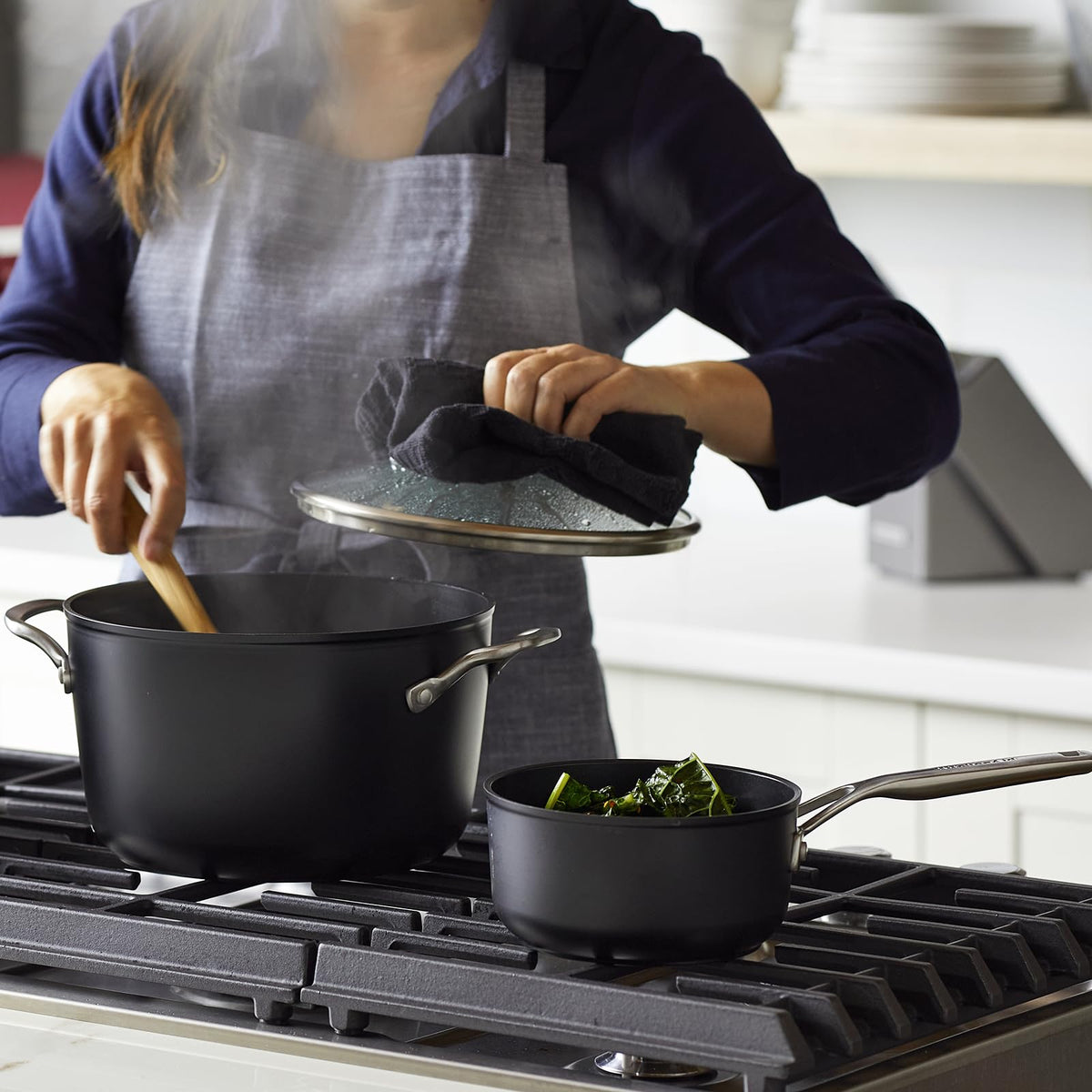 Matte black finish and durable build of KitchenAid cookware set.