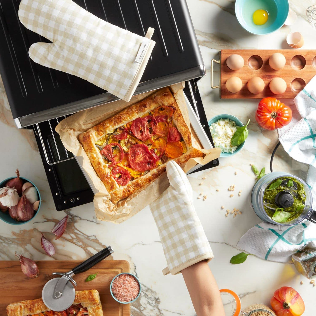 Two KitchenAid Gingham oven mitts on display for versatile use