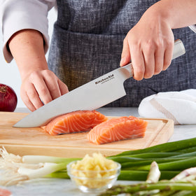 KitchenAid Gourmet 5.5-inch serrated utility knife ideal for crusts and tomatoes.