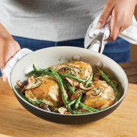 KitchenAid pan on a stovetop illustrating seamless stove-to-table use