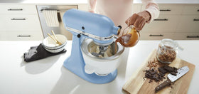 KitchenAid ice cream maker attachment mounted on tilt-head mixer enables small-batch creations.