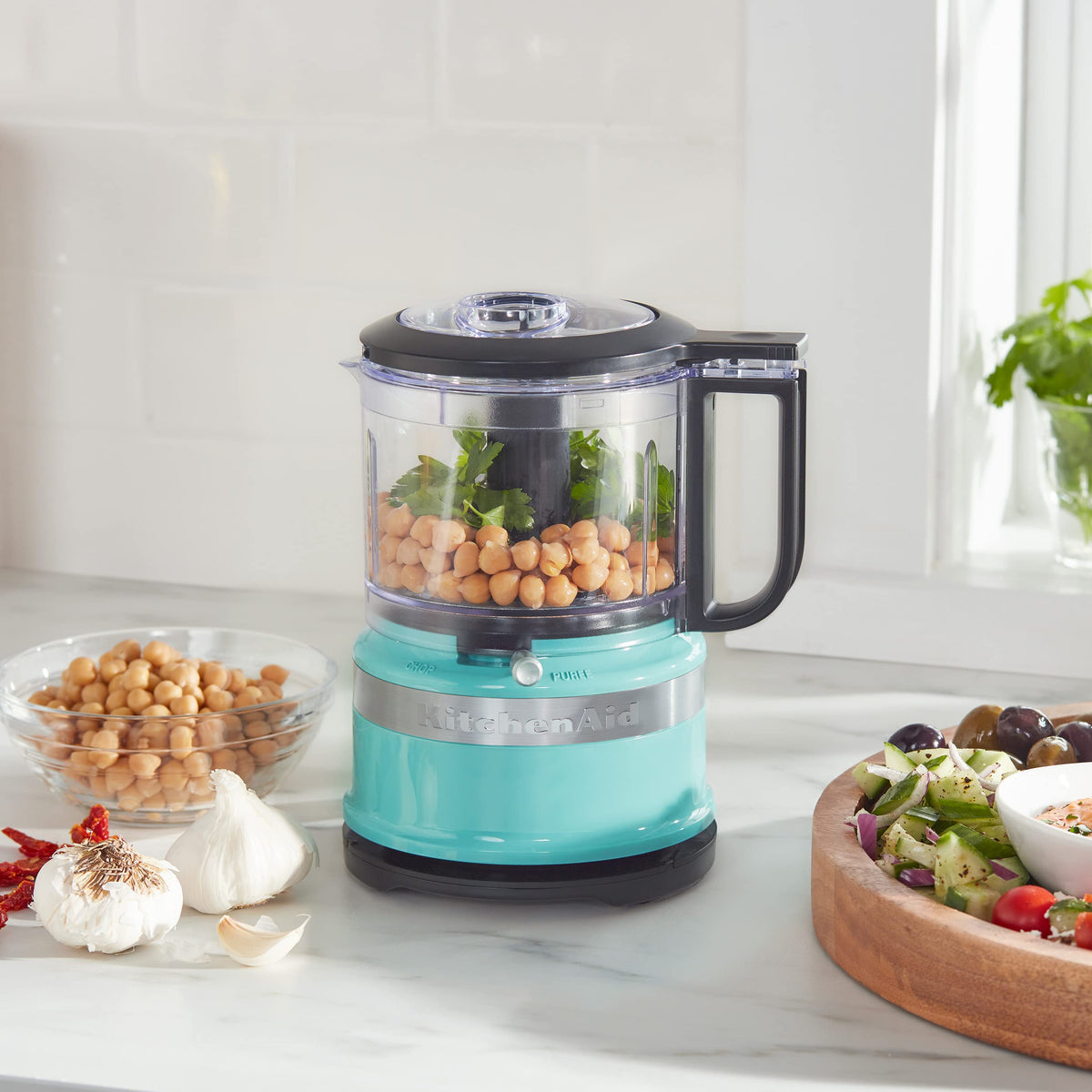 KitchenAid KFC3516AQ drizzle basin supports sauces and dressings during processing.