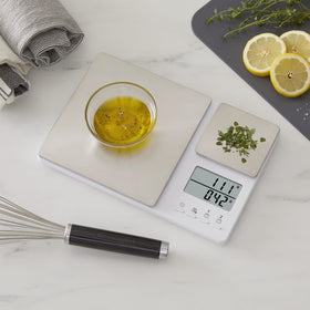 KitchenAid KQ909 tare feature zeros containers between ingredients for clean weighing.