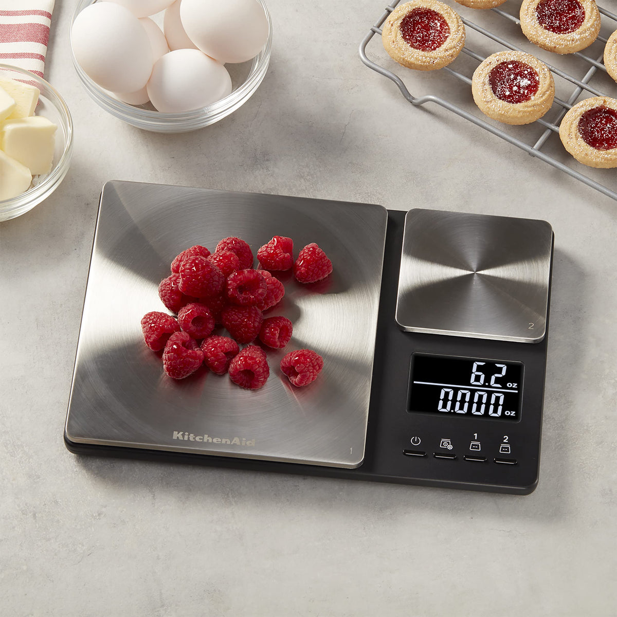 KitchenAid KQ909 tare function allows zeroing containers between ingredients.