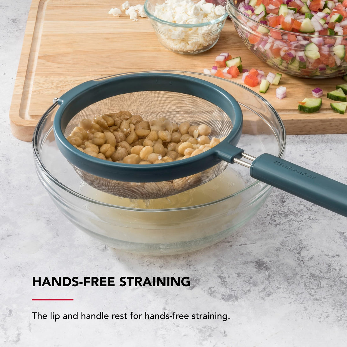 KitchenAid mesh strainer with ergonomic, weighted handle for comfort and control.