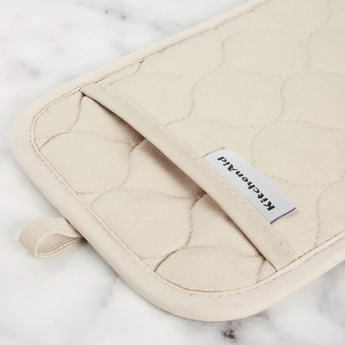 KitchenAid oven mitt with silicone grip enables non-slip handling of hot pans.