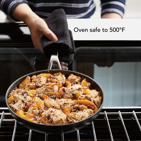 Tempered-glass lids on KitchenAid set for heat retention.