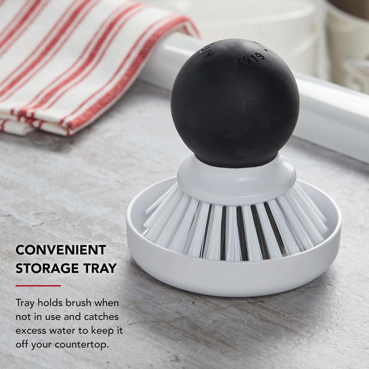 KitchenAid palm brush with storage dish to catch drips and protect countertops.