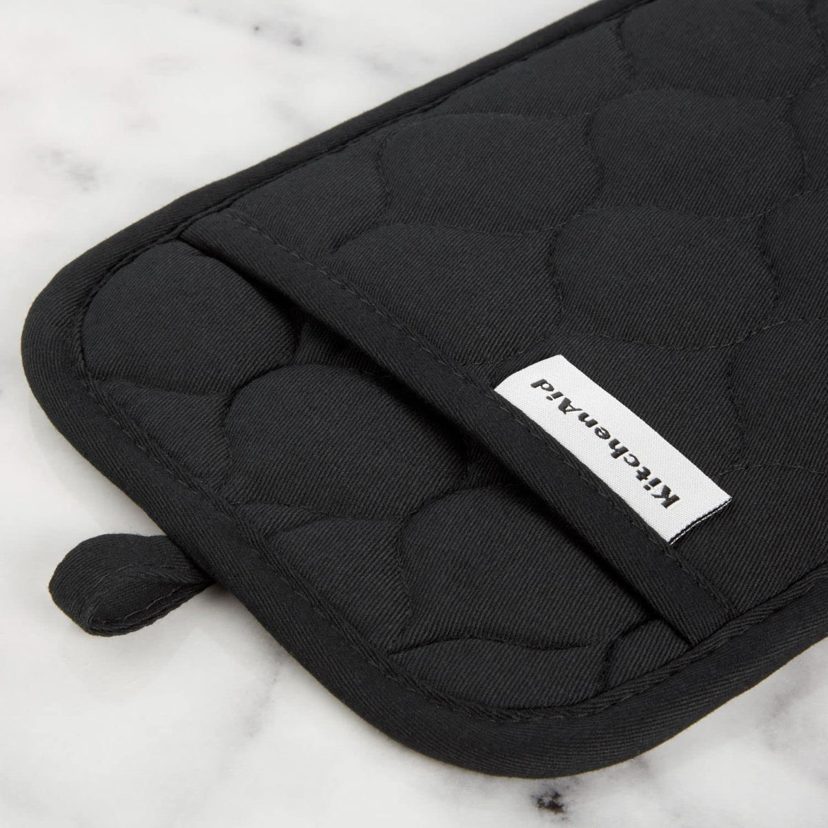 KitchenAid pot holder shows dual-layer construction for steady pan handling.