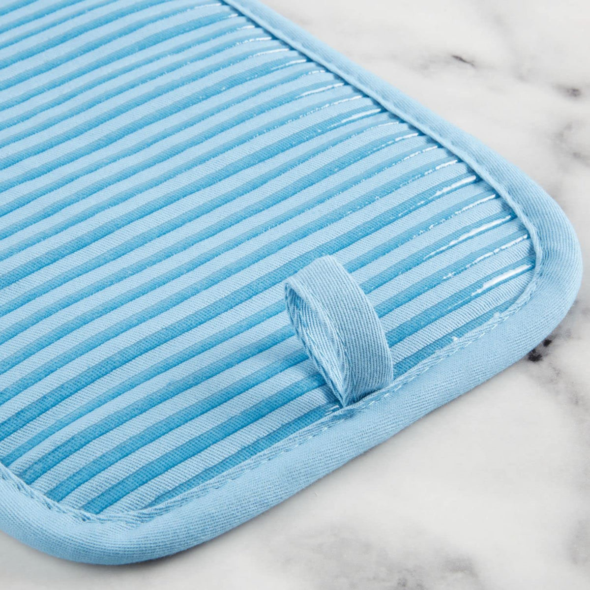 Folded KitchenAid blue velvet kitchen towel showing absorbent terrycloth texture.