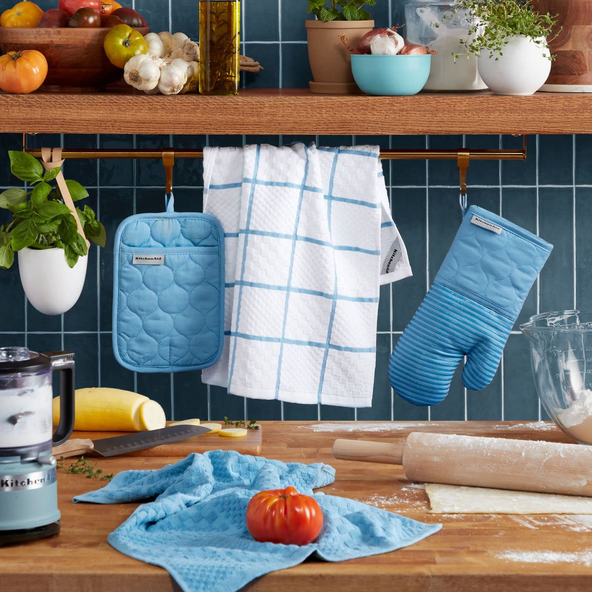 Close view of KitchenAid blue velvet oven mitt showing thick quilted construction.