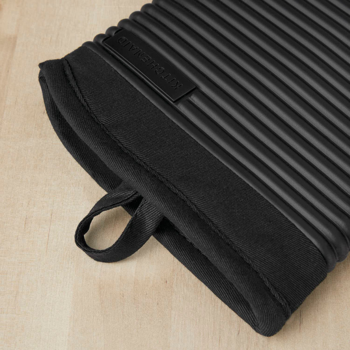 Close-up of KitchenAid ribbed silicone mitten grip detail for confident lifting of hot pans