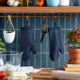 KitchenAid ink blue mitts resist heat up to 500°F for safe oven transfers.