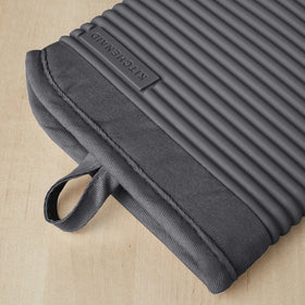 KitchenAid ribbed silicone oven mitt demonstrating textured grip for safe pan handling