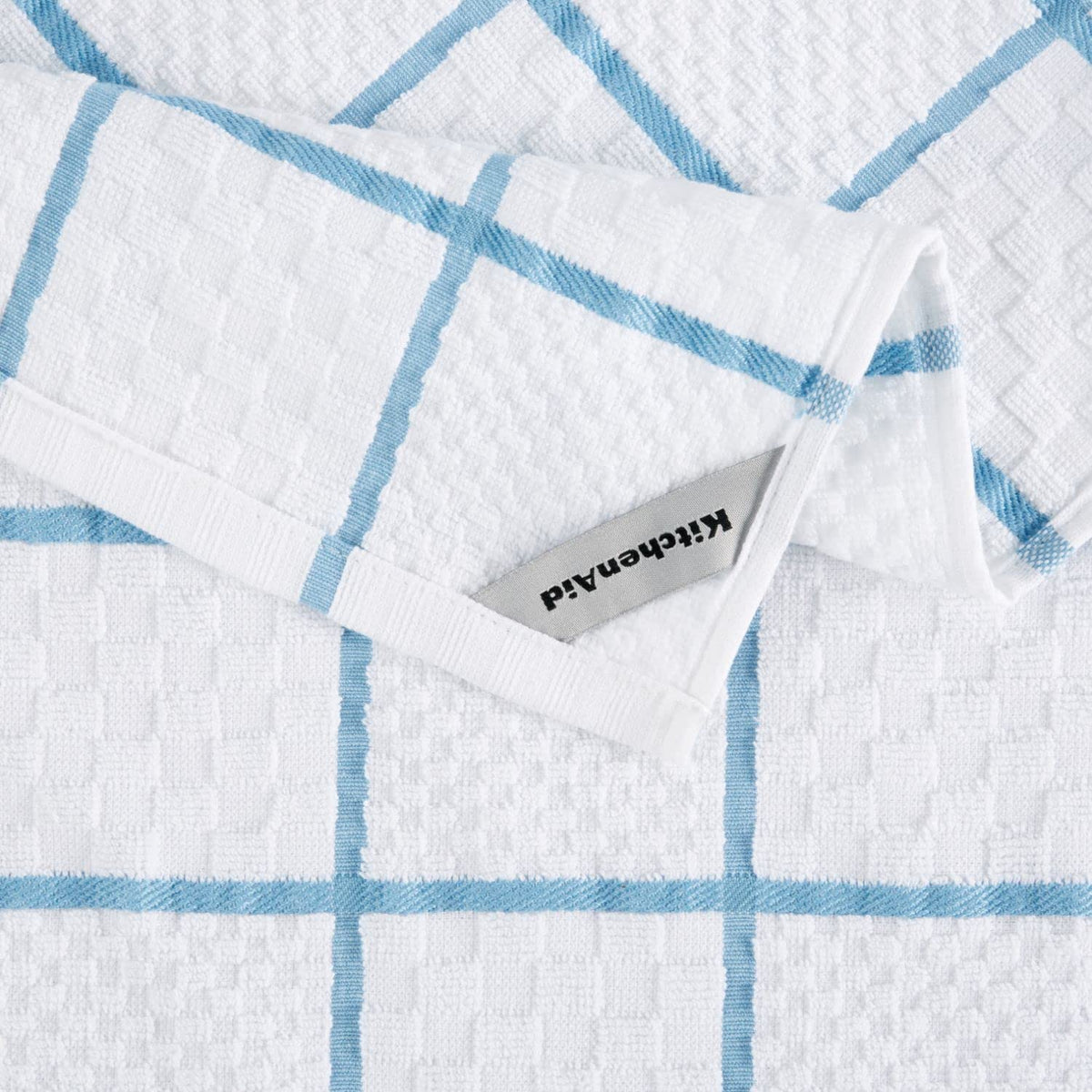 Close-up of silicone grip on KitchenAid oven mitt for secure handling.