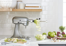 KitchenAid spiralizer in use on zucchini to create veggie noodles.