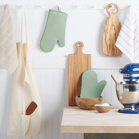 KitchenAid pistachio ribbed silicone mitts offer textured grip for safe stovetop handling.