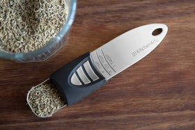 KitchenArt measuring spoons in silver finish highlighting the sliding mechanism for easy selection.