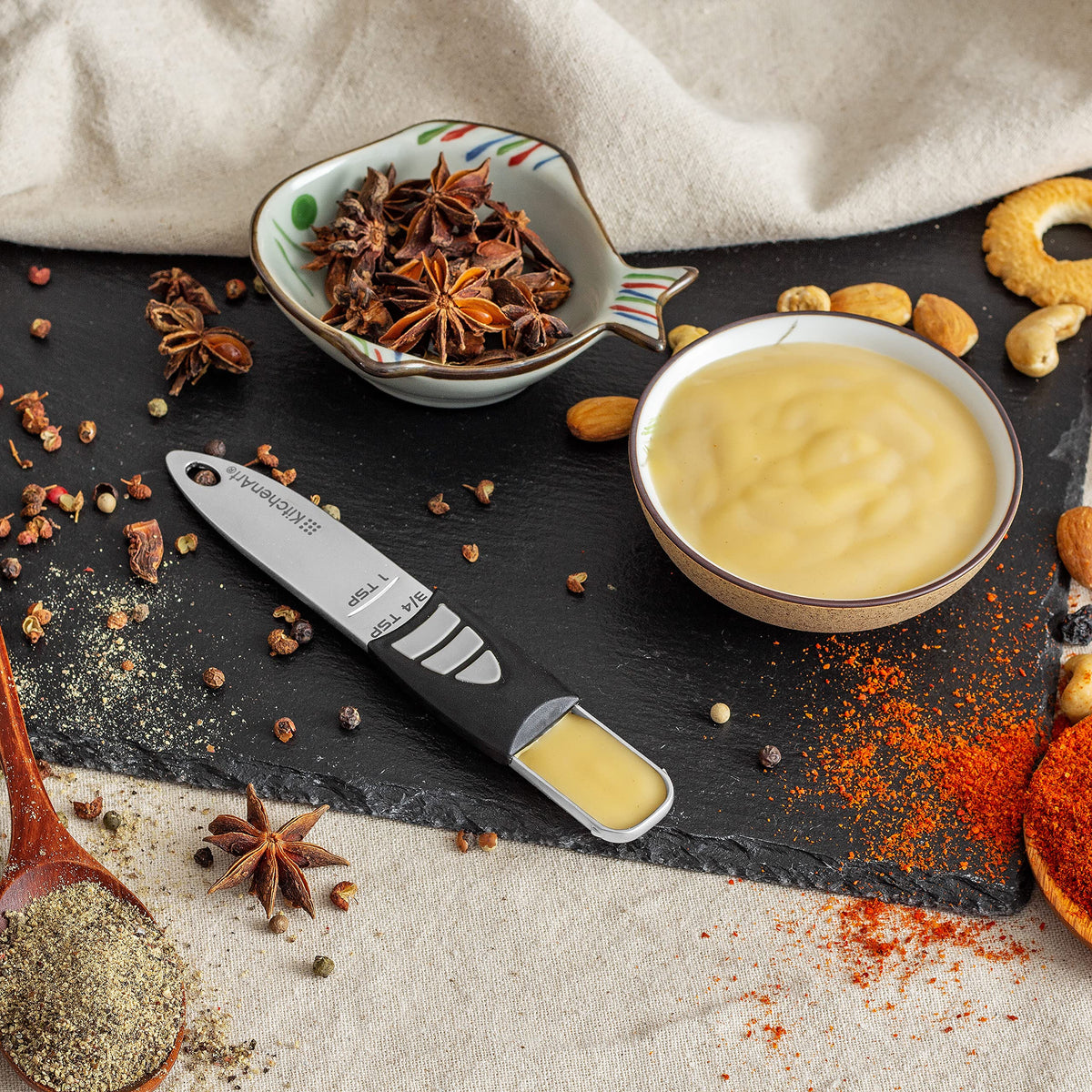 KitchenArt adjustable spoon with angled edge for effortless leveling and clean scoops.