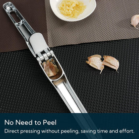 KITCHENDAO garlic press in use, producing smooth paste for sauces.