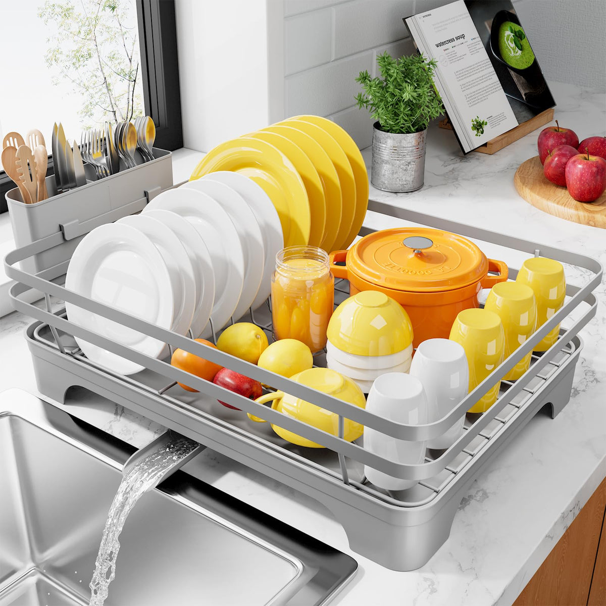 Kitsure dish drying rack with rotatable spout directing water away from the counter.