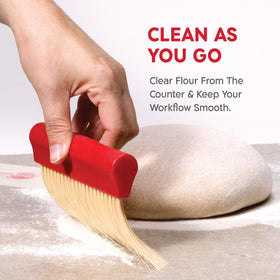 KneadAce flour-dusting tool in action for even flour distribution