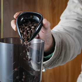 KNODOS static-reduction bottle sprayer minimizes cling on coffee grounds.