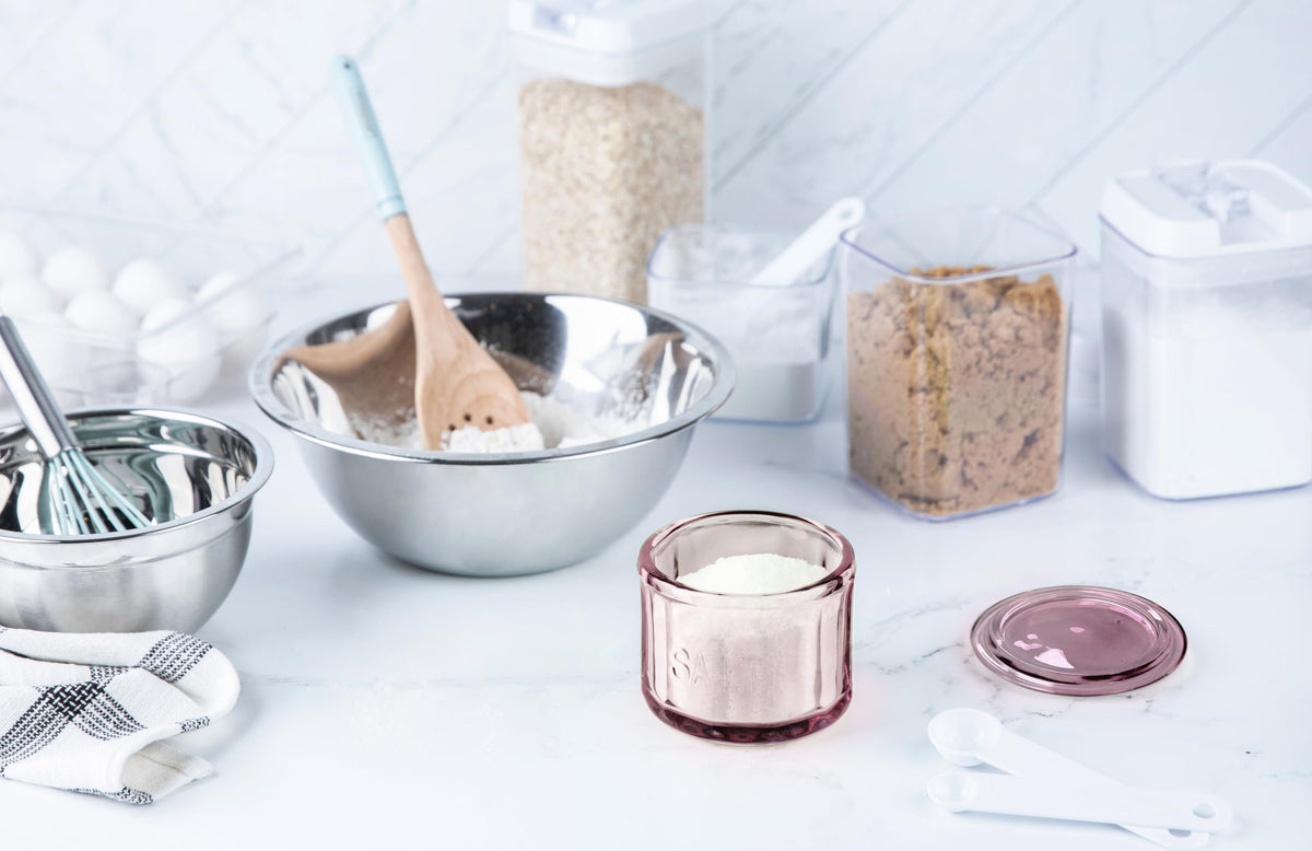 Pink lid fits snugly on a glass salt cellar for dry, fresh contents