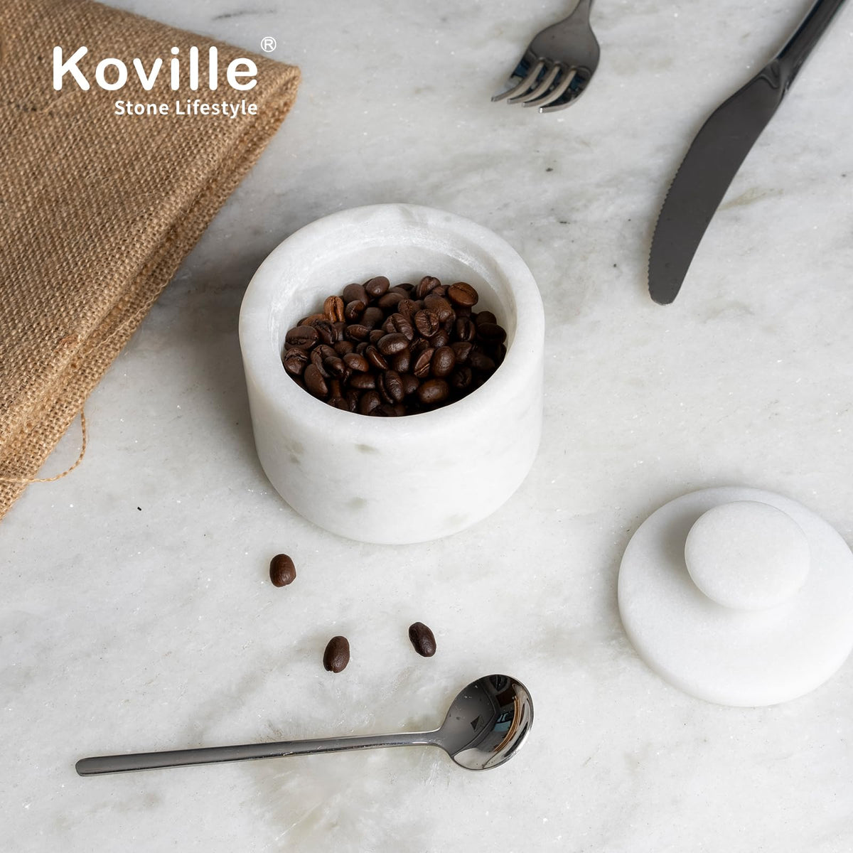 Koville kitchen counter display of white marble jars for everyday use.