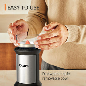 KRUPS electric blade coffee grinder lid operation demonstrates push-controlled grinding.