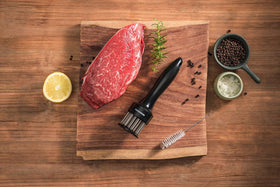 KUCCOON tenderizer on kitchen counter beside marinade for practical use.