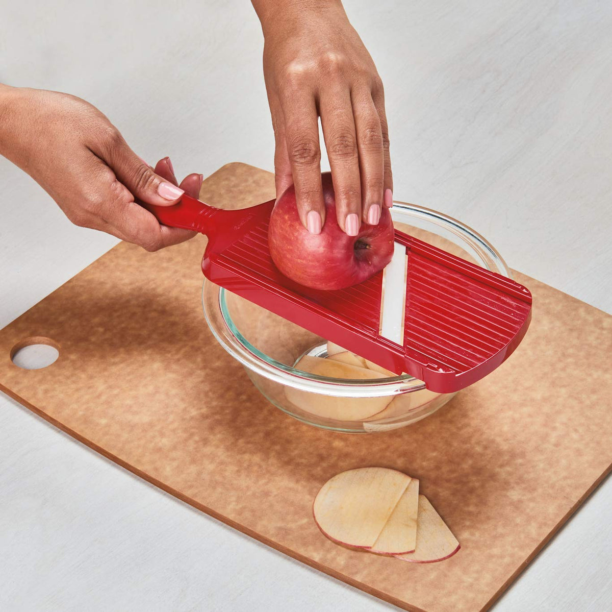 Kyocera slicer positioned over bowl for stable, mess-free prep