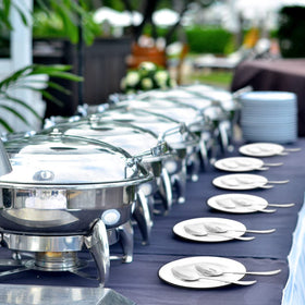LayHyand serving spoons on a dining table ready for salads and entrees.