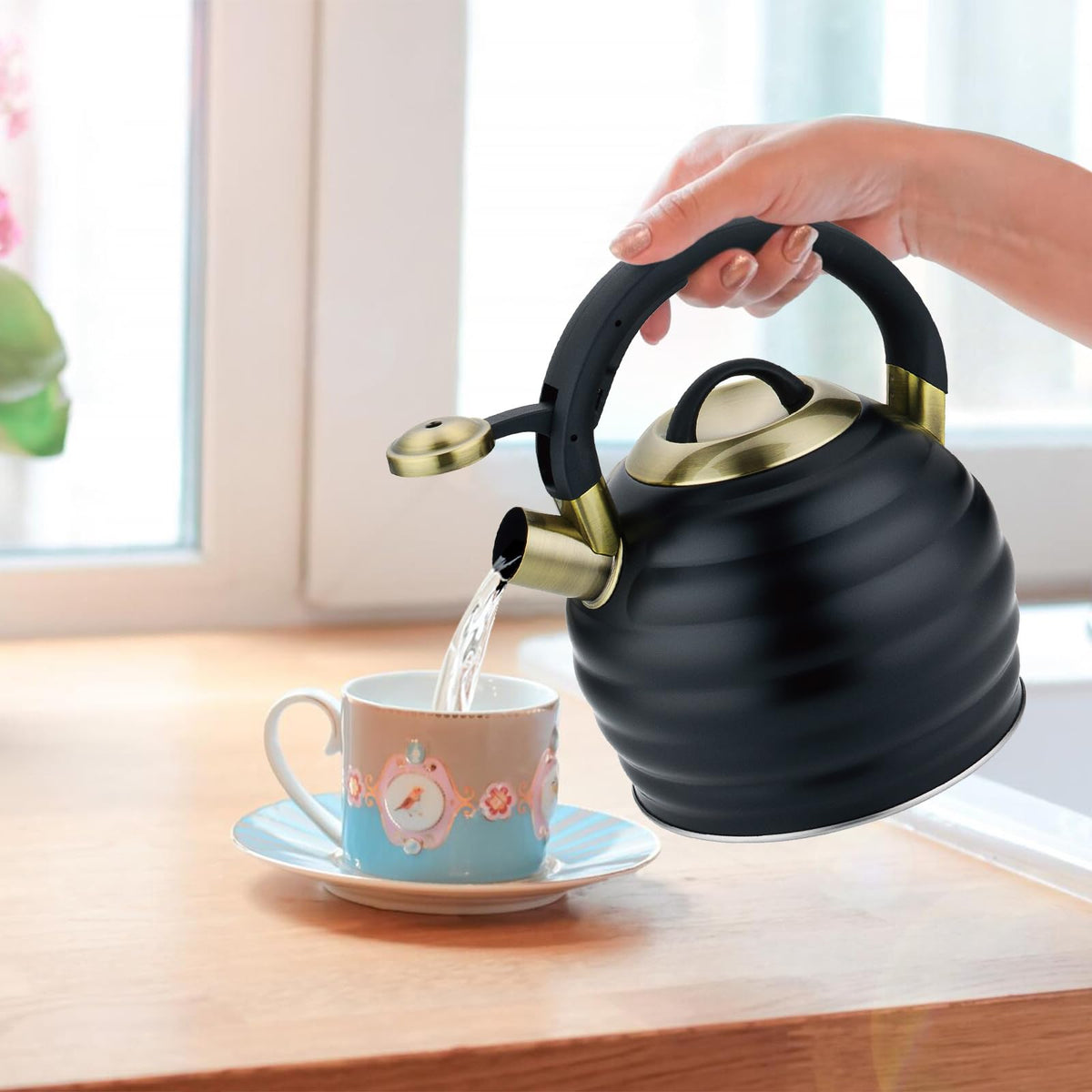 Lazneyru teapot in action being poured with one-hand trigger mechanism.