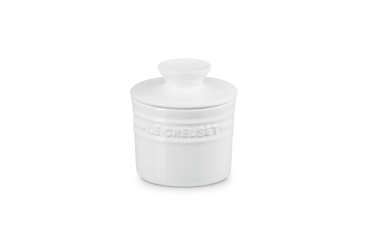 Le Creuset white butter crock on the counter in a classic kitchen setting