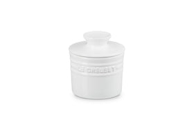 Le Creuset white butter crock on the counter in a classic kitchen setting