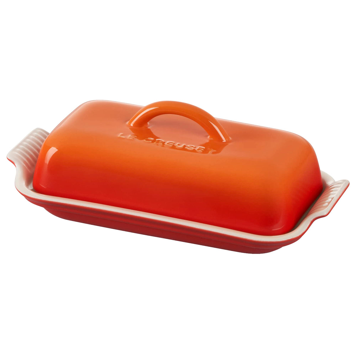 Le Creuset Heritage Flame butter dish on table, vibrant glaze, compact and easy to serve.