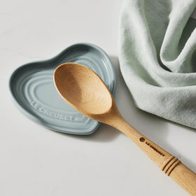 Le Creuset spoon rest in cerise, dishwasher-safe for easy cleaning.