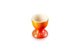 Le Creuset 2-inch Flame egg cup with bright glaze for warm servings.