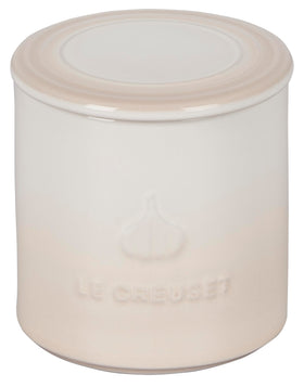 Le Creuset garlic keeper meringue on counter for easy garlic storage.