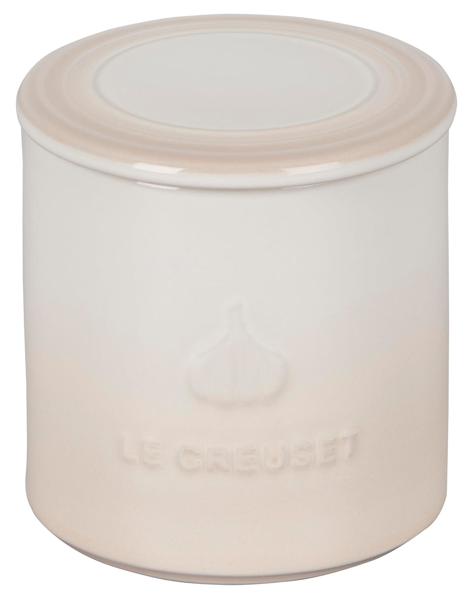 Le Creuset garlic keeper meringue on counter for easy garlic storage.