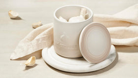 Le Creuset garlic keeper meringue with open lid, showing inner surface for quick prep.