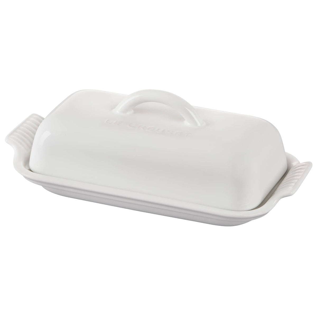 Le Creuset Heritage butter dish on table with glossy glaze for easy serving.