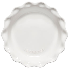 Le Creuset Heritage Pie Dish on table for oven-to-table presentation and glaze.