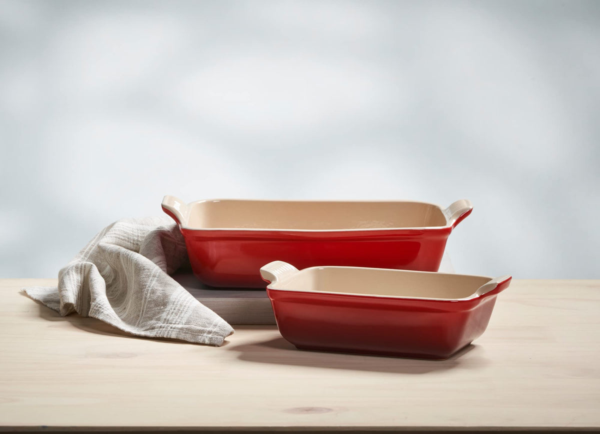 Le Creuset Heritage 10-inch rectangular dish in cerise, versatile for roasting and serving.