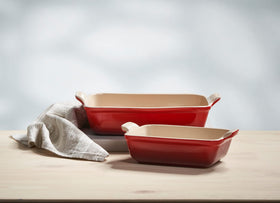Le Creuset Heritage 10-inch rectangular dish in cerise, versatile for roasting and serving.